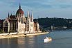 Budapest Parliament On The Danube Bankside And Tourist Boat